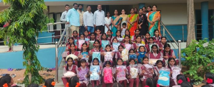 Distribution of clothes to female students on the occasion of Nagula Panchami
