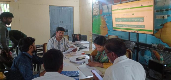 AO Raju examined farmer insurance applications..