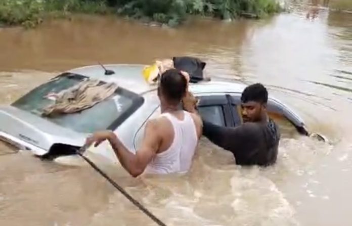 Car washed away in a stream due to heavy rain
