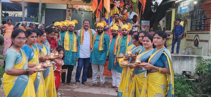 Immersion procession with uniform attire and Sannai Mela