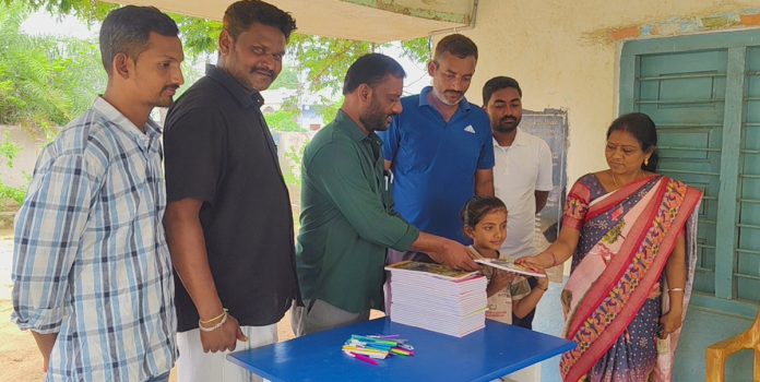 Distribution of notebooks and pens to students