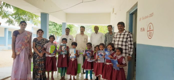 Distribution of notebooks pens and pencils in memory of father