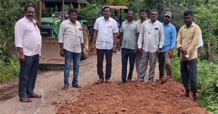 Temporary repairs to road potholes at Tirupati Goud..