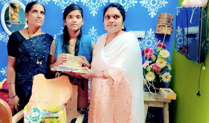 Handing over notebooks to the student