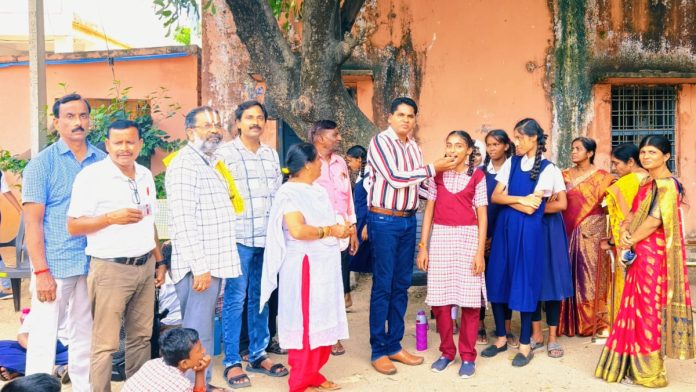 Distribution of deworming tablets to students in Perkit