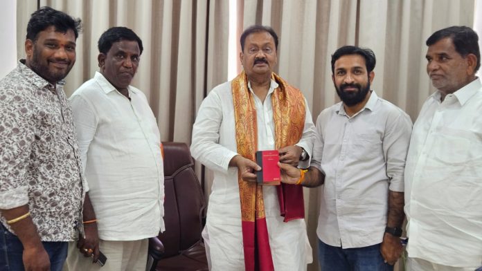 Shabbir Ali presented with the Constitution Booklet