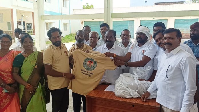 Library Chairman Kedam Lingamurthy distributed T-shirts to workers