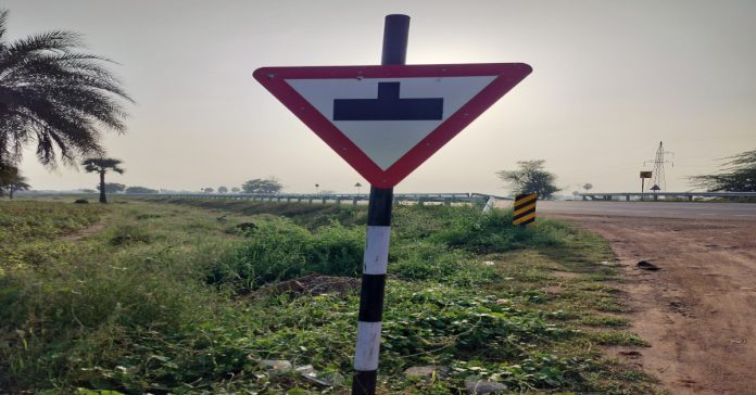 Reverse intersection sign board on bypass road