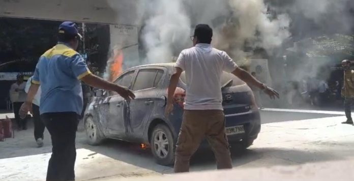A car suddenly catches fire at a petrol pump.