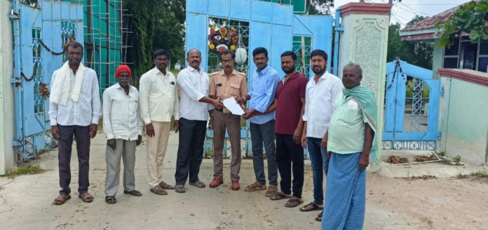 Villagers protest in front of chicken farm..