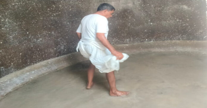Sarpanch cleaning the water tank