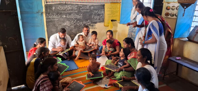 Group literacy and food distribution at Anganwadi center